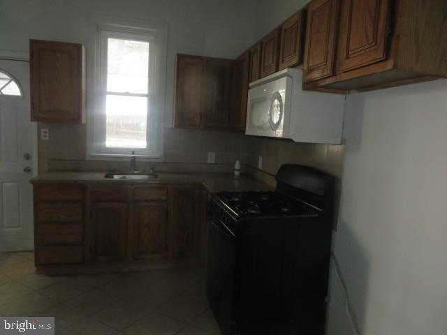 823 Hutton Street Philadelphia, PA 19104 - Photo 5 of 11 a kitchen with a sink and cabinets
