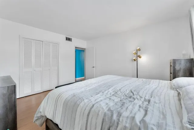 a bedroom with a bed and a closet