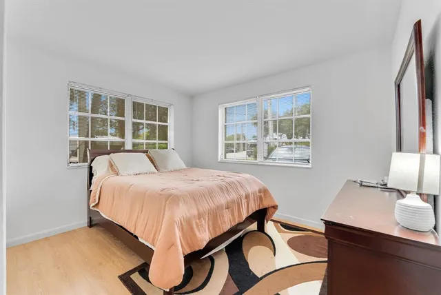 a spacious bedroom with a large bed and a window