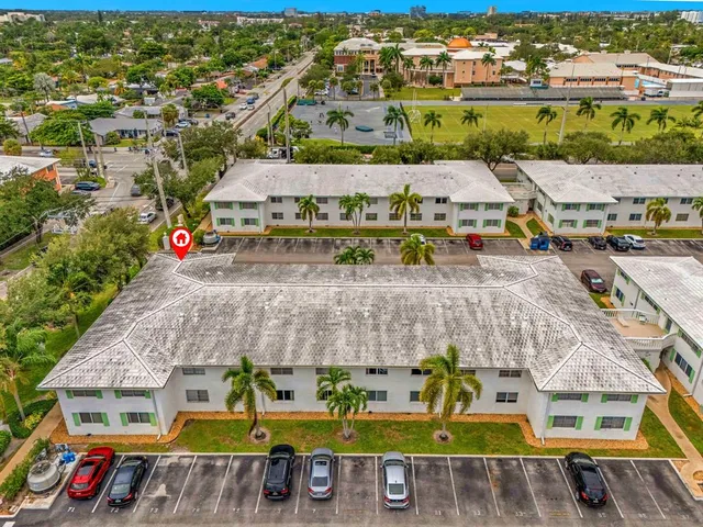 an aerial view of houses with a swimming pool