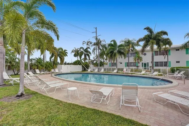 a view of a backyard with swimming pool