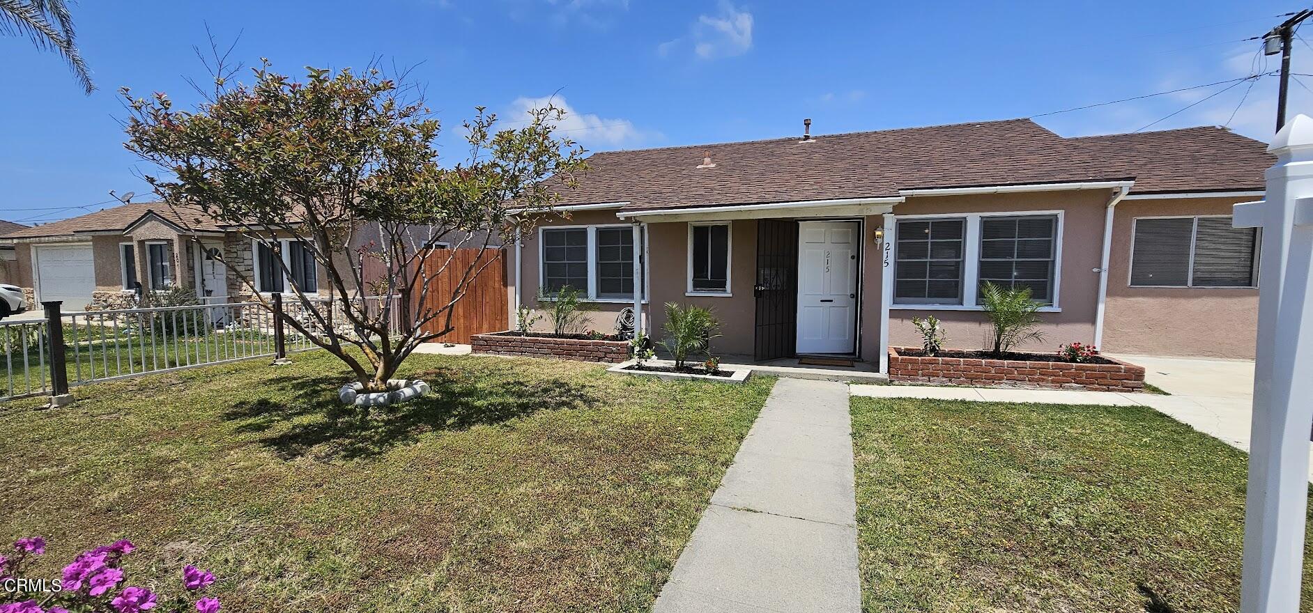 front view of a house with a yard