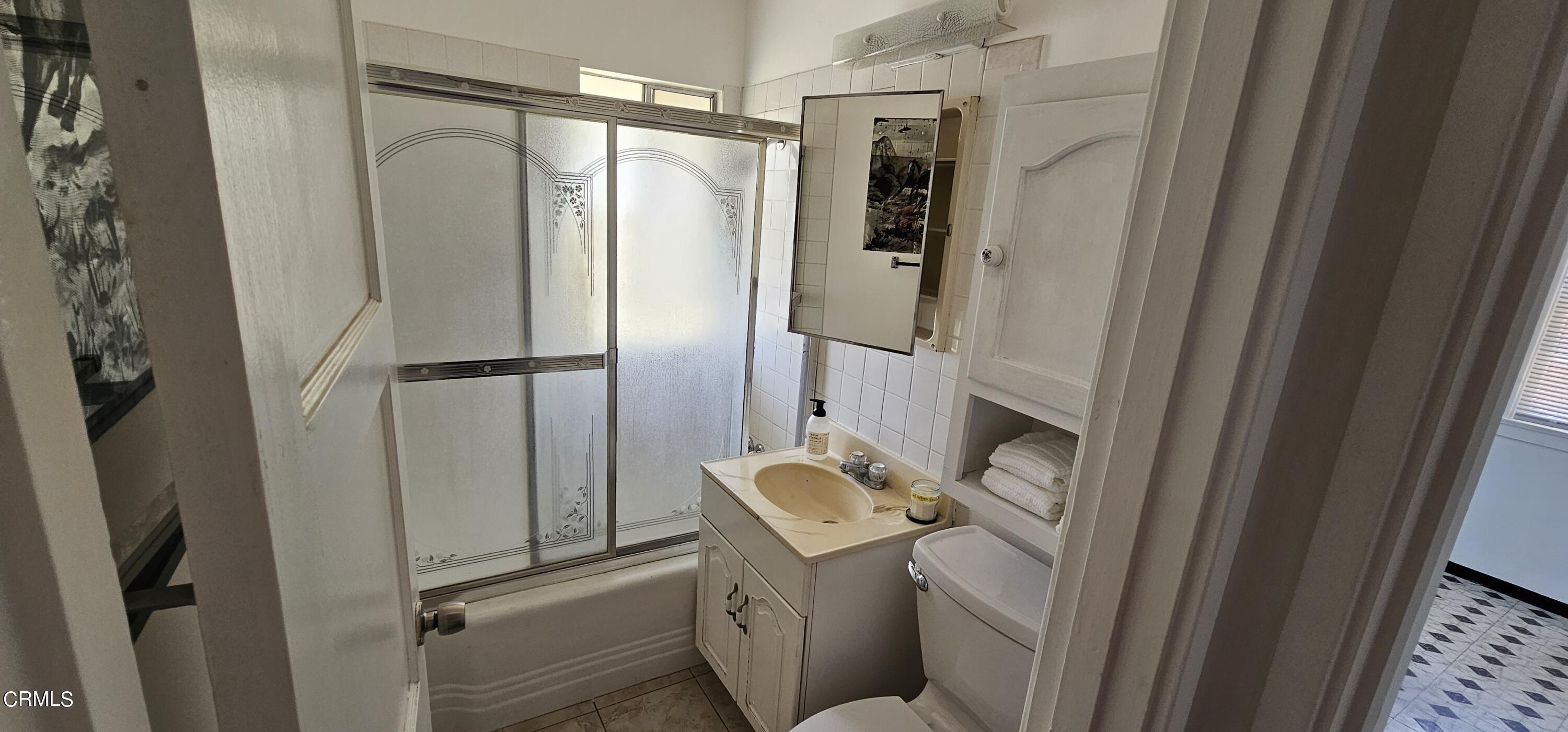 215 Thomas Avenue Oxnard, CA 93033 - Photo 11 of 18 a bathroom with a sink toilet and shower