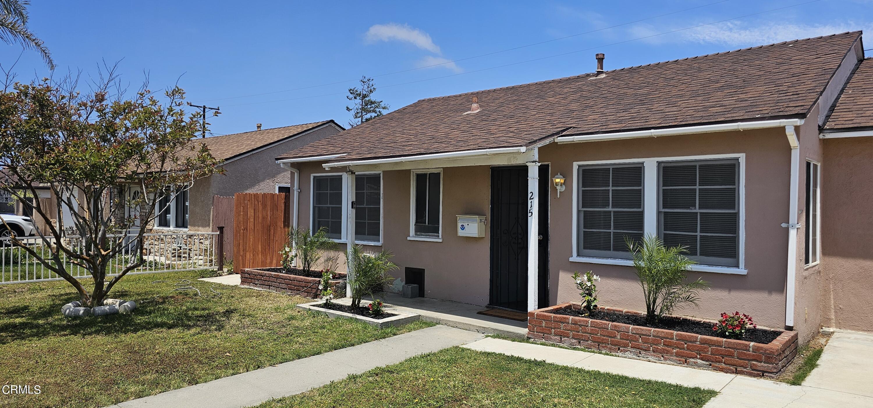 215 Thomas Avenue Oxnard, CA 93033 - Photo 2 of 18 a front view of a house with garden