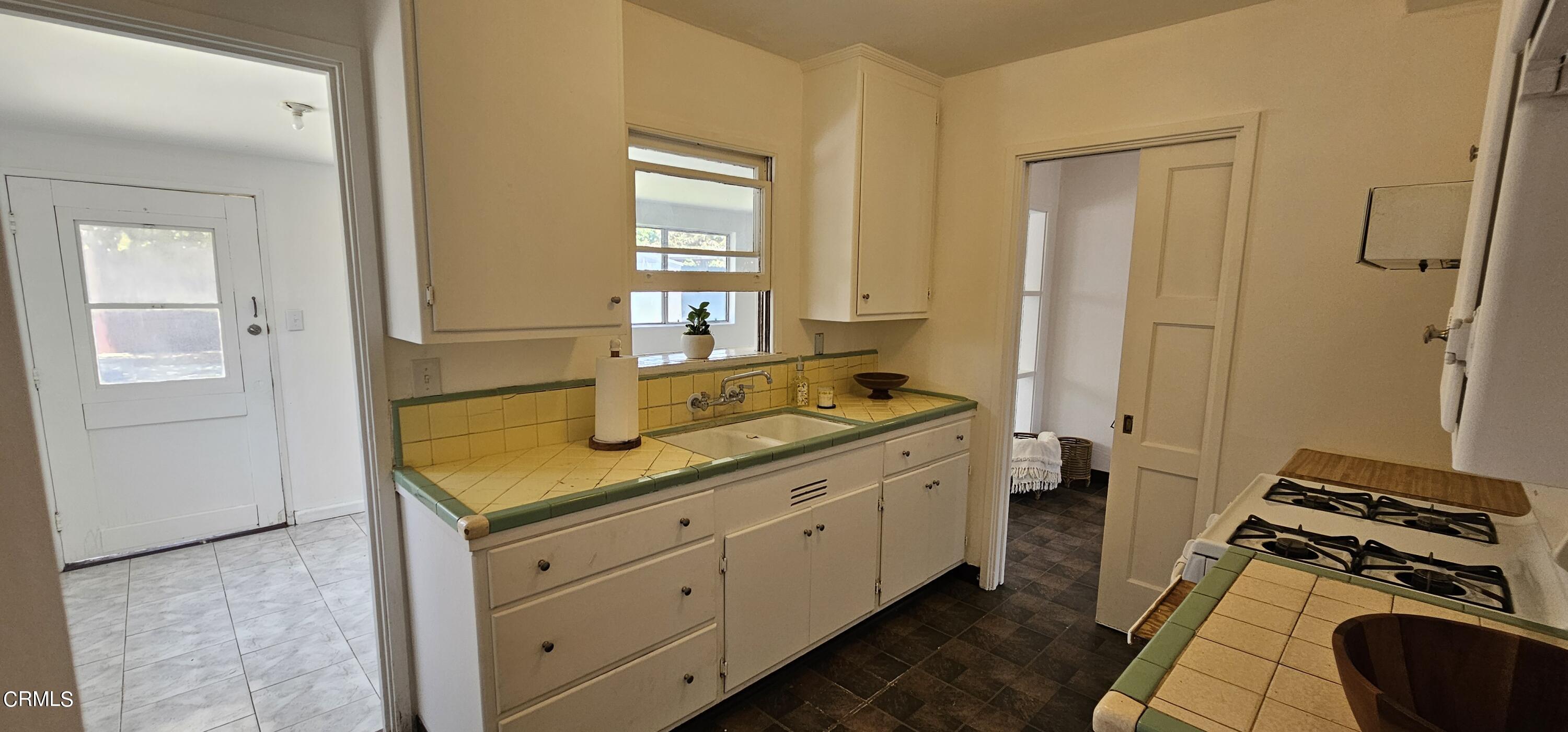 215 Thomas Avenue Oxnard, CA 93033 - Photo 6 of 18 a kitchen with a sink and a stove top oven