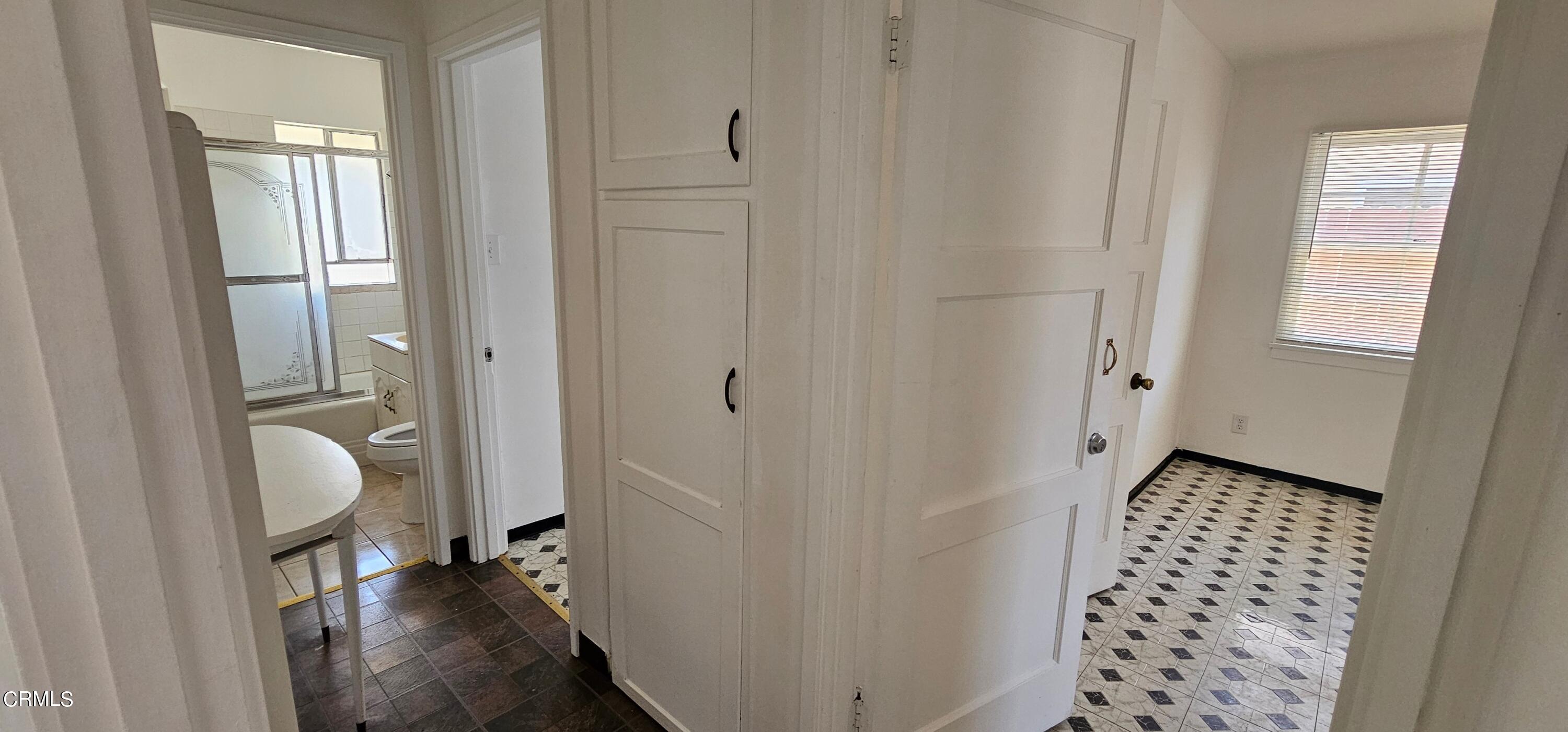 215 Thomas Avenue Oxnard, CA 93033 - Photo 9 of 18 a view of a hallway with bathroom and wooden floor