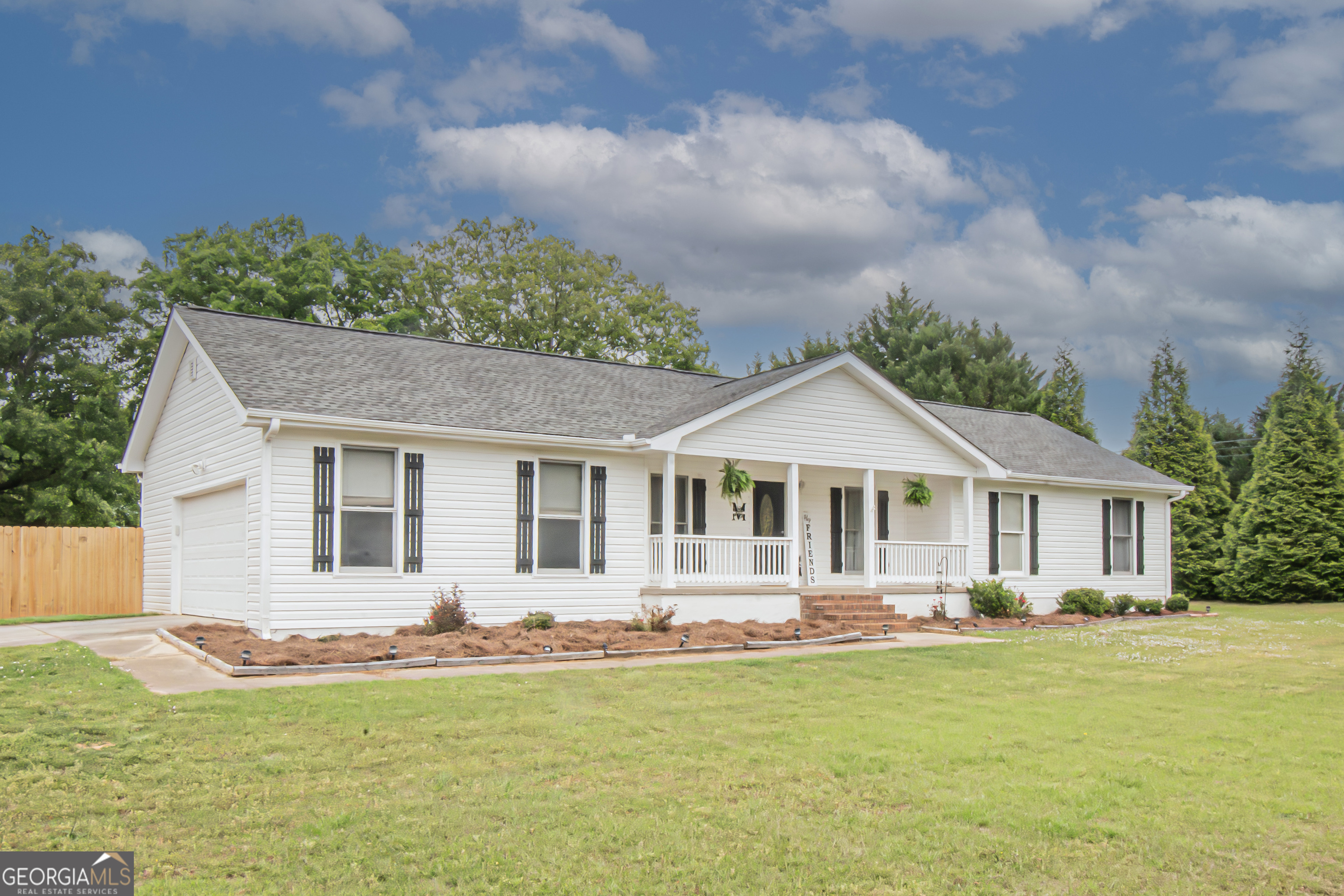225 Graystone Drive Covington, GA 30014 - Photo 2 of 23 a front view of a house with a garden and yard