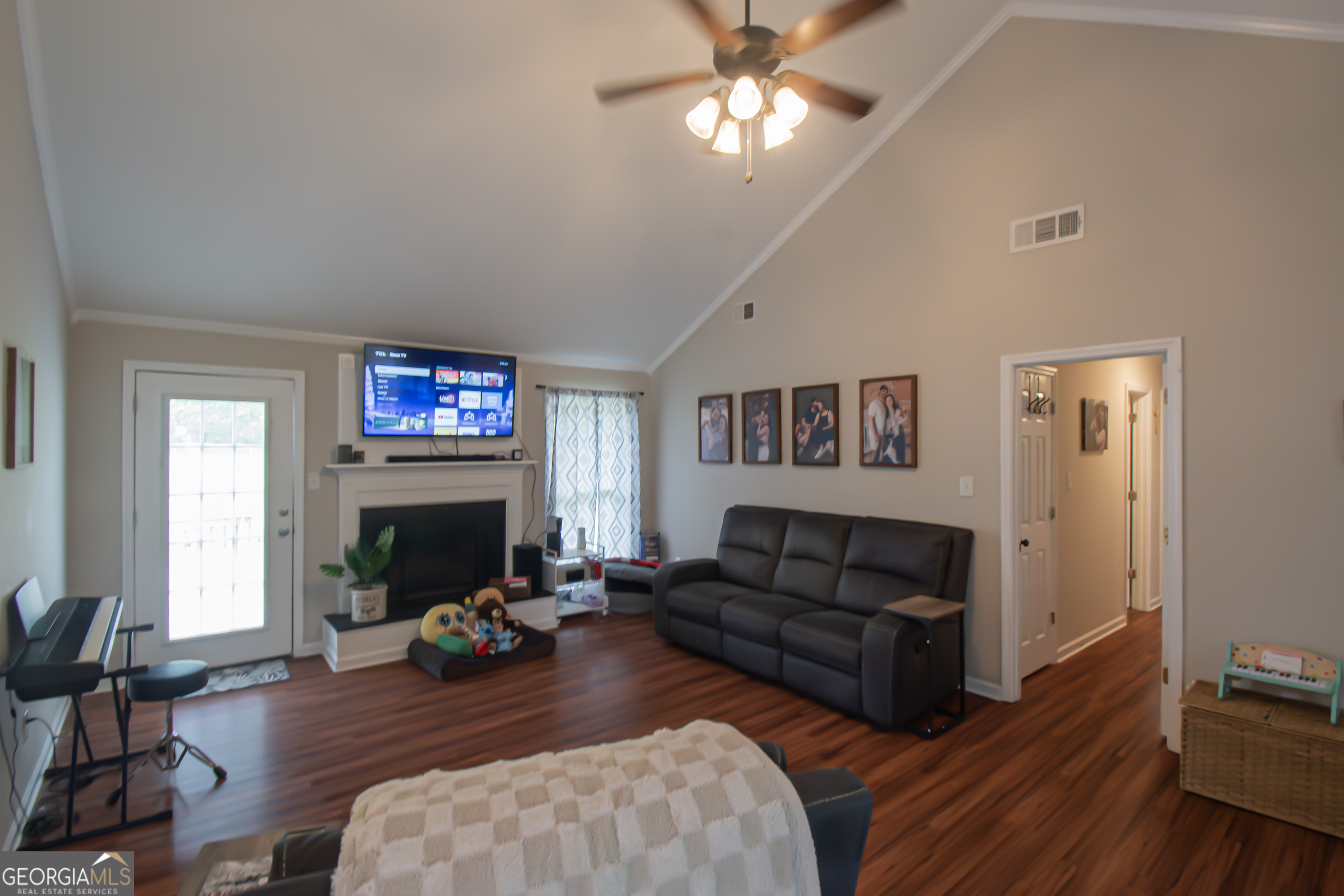 225 Graystone Drive Covington, GA 30014 - Photo 3 of 23 a living room with furniture a fireplace and wooden floor
