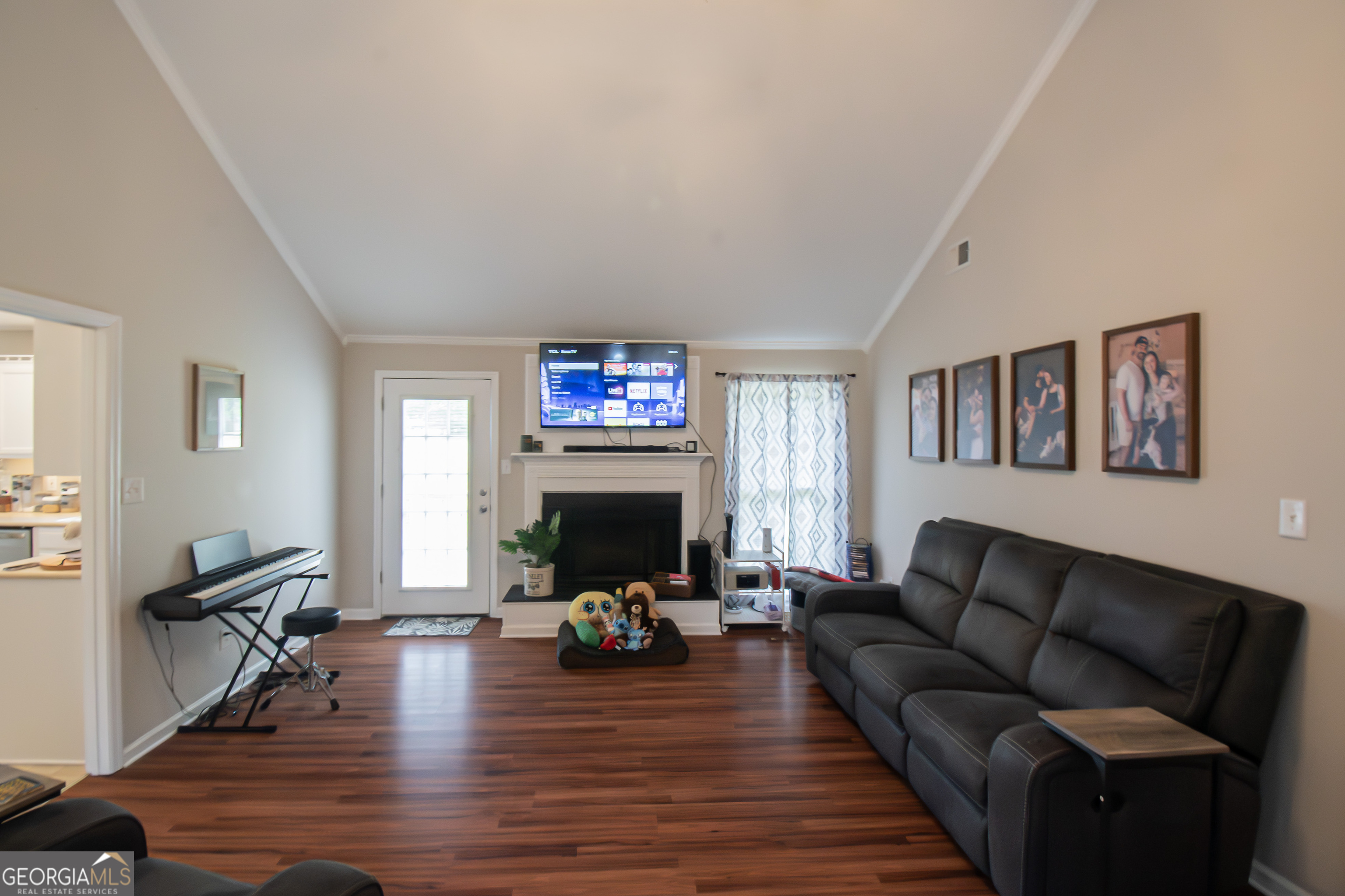 225 Graystone Drive Covington, GA 30014 - Photo 4 of 23 a living room with furniture a fireplace and a flat screen tv