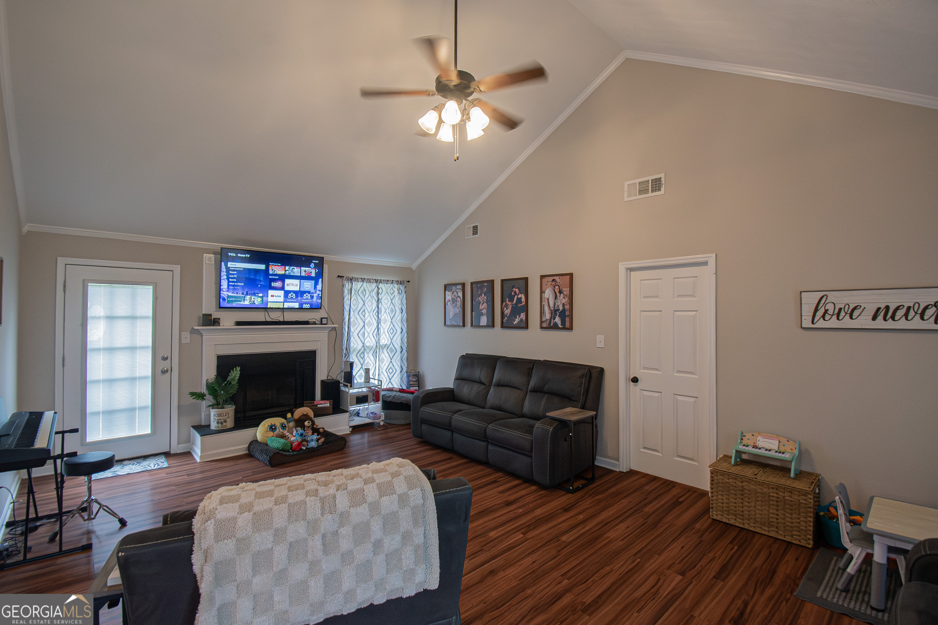 225 Graystone Drive Covington, GA 30014 - Photo 7 of 23 a living room with furniture a fireplace and a flat screen tv