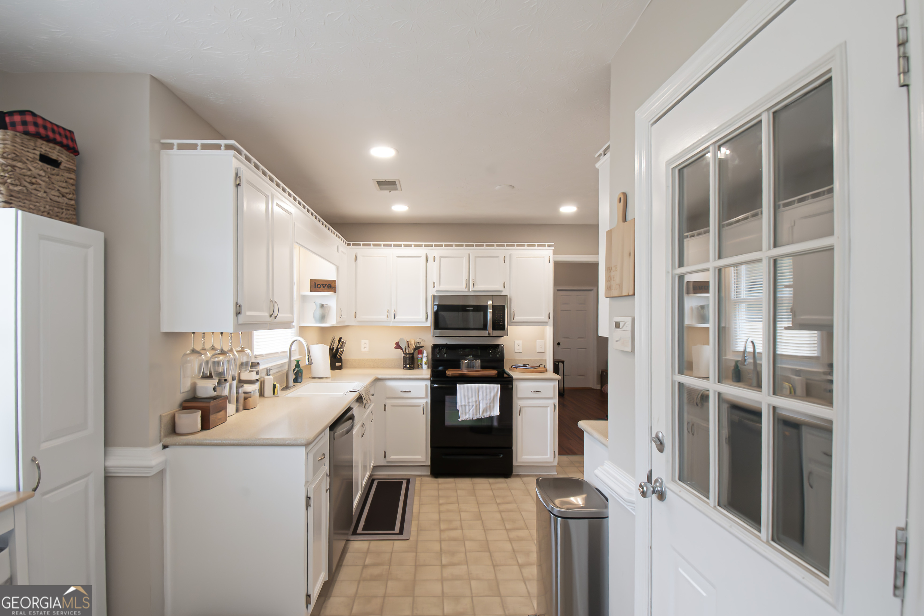 225 Graystone Drive Covington, GA 30014 - Photo 10 of 23 a kitchen with a refrigerator and a stove