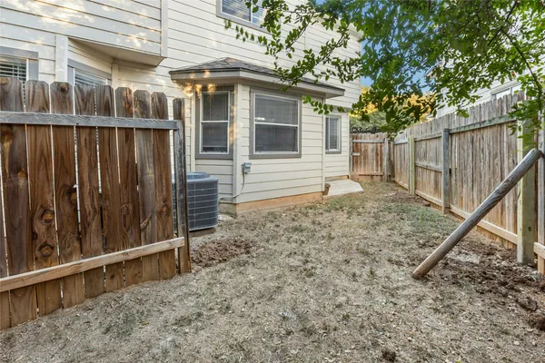 a view of a house with a wooden fence