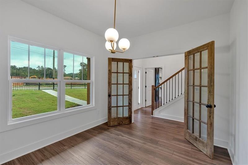 133 Old Alabama Road Southeast Emerson, GA 30137 - Photo 8 of 44 a view of an empty room with wooden floor and a window