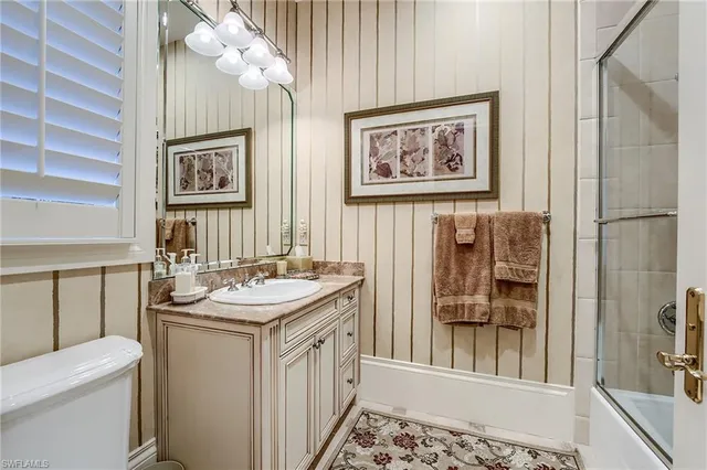 a bathroom with a sink a toilet and a window