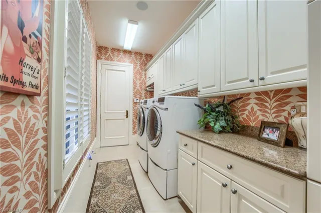 a kitchen with granite countertop a white stove top oven a sink and dishwasher