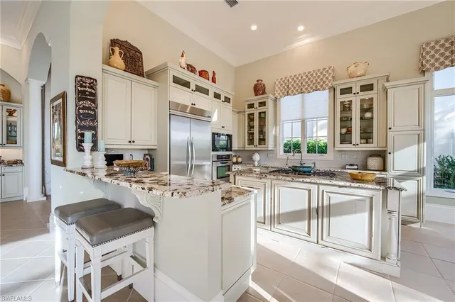 a kitchen with stainless steel appliances kitchen island granite countertop a sink and cabinets