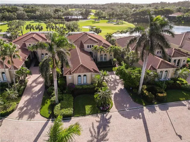 an aerial view of a house with a swimming pool yard and mountain view in back