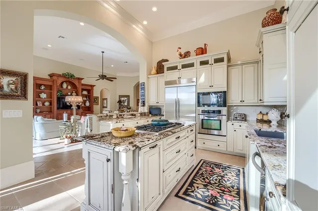 a kitchen with stainless steel appliances kitchen island granite countertop a sink and cabinets