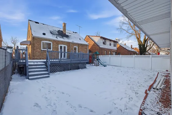 a view of a house with a snow in the yard