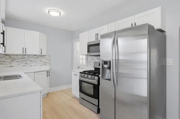 a kitchen with a refrigerator stove and microwave