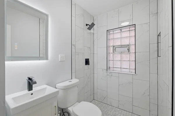 a bathroom with a sink toilet and shower