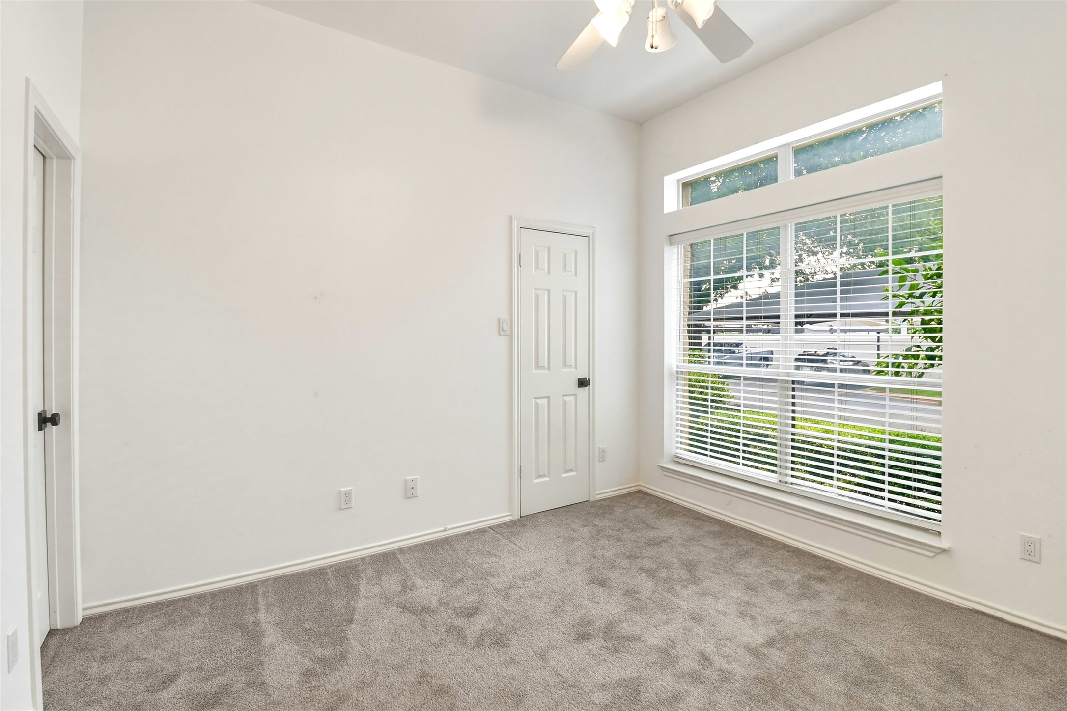 2918 Ranch Road 620, Unit 265 Austin, TX 78734 - Photo 14 of 40 A quiet bedroom featuring lofty ceilings, abundant natural light, and plush gray carpeting.