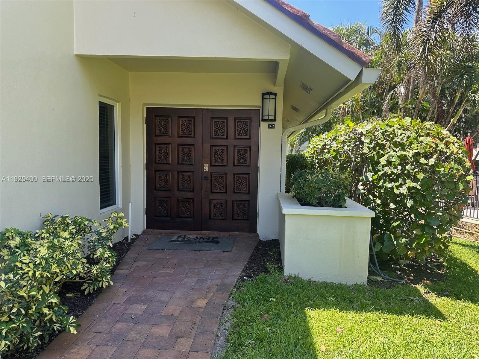 4161 South Us Highway, Unit G2 Jupiter, FL 33477 - Photo 14 of 62 a front view of a house with a yard