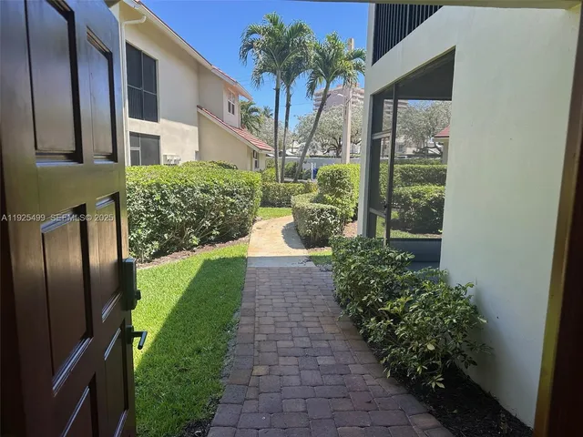 a kitchen with stainless steel appliances granite countertop a refrigerator a sink dishwasher a stove a washer and dryer next to a window