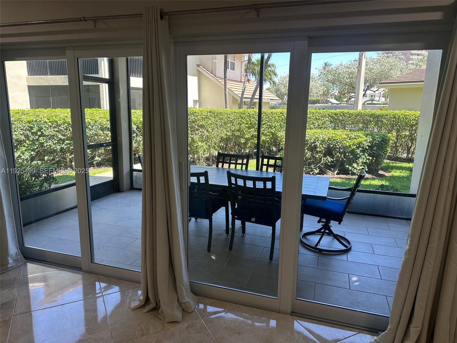 4161 South Us Highway, Unit G2 Jupiter, FL 33477 - Photo 33 of 62 a living room with furniture and a floor to ceiling window