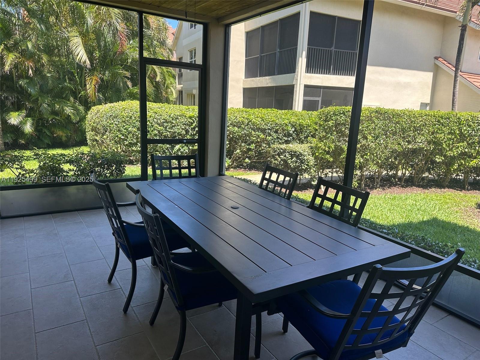 4161 South Us Highway, Unit G2 Jupiter, FL 33477 - Photo 36 of 62 a view of a wooden table and chairs in patio of a house
