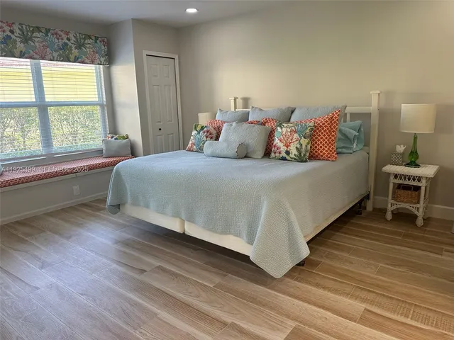 a bed sitting in a bedroom next to a window