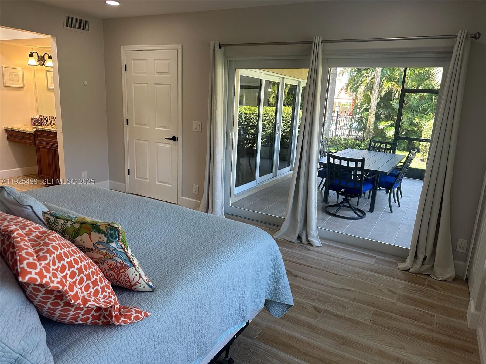 4161 South Us Highway, Unit G2 Jupiter, FL 33477 - Photo 39 of 62 a bedroom with a bed and a large window