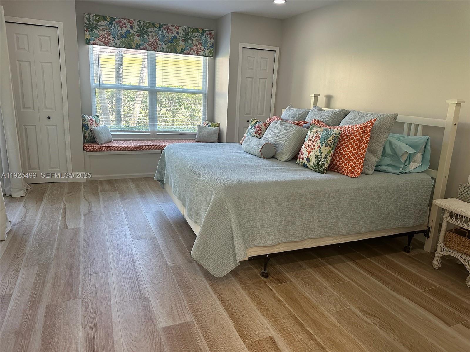 4161 South Us Highway, Unit G2 Jupiter, FL 33477 - Photo 47 of 62 a bed sitting in a bedroom next to a window