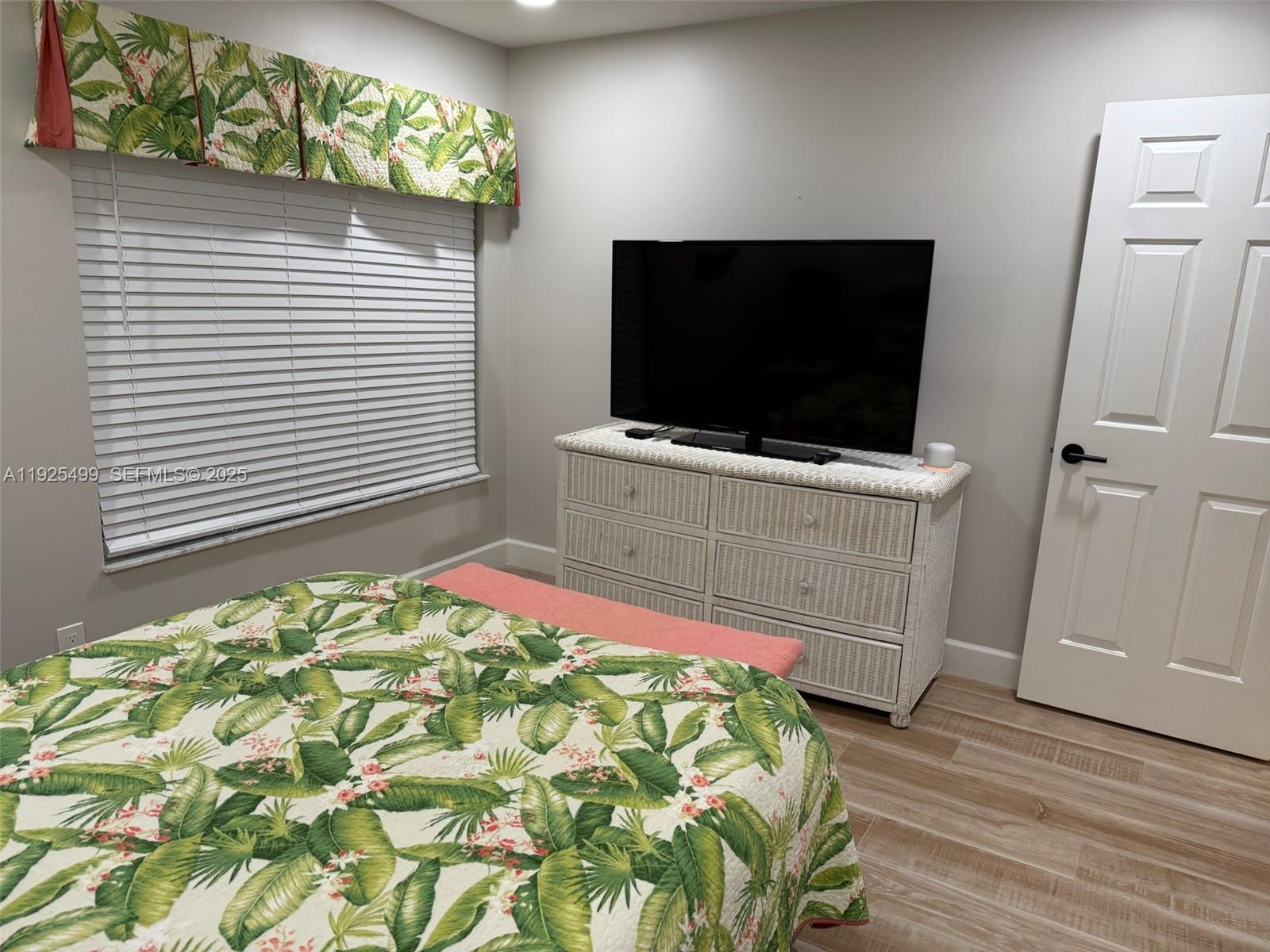 4161 South Us Highway, Unit G2 Jupiter, FL 33477 - Photo 52 of 62 a bedroom with a bed and a flat screen tv