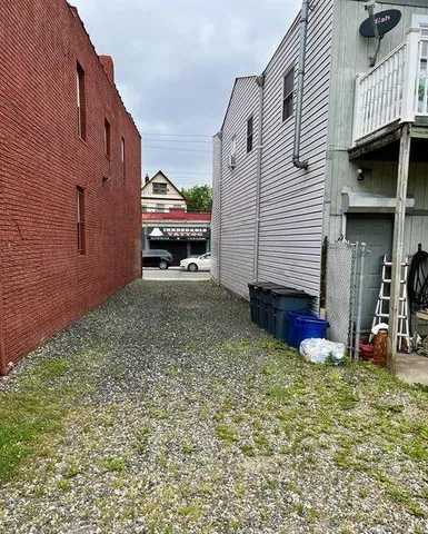 a view of a house with a yard and sitting area