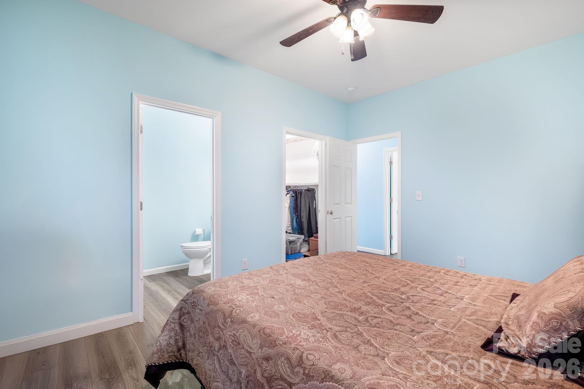 845 Spindale Street Spindale, NC 28160 - Photo 19 of 27 a bedroom with a large bed and a chandelier