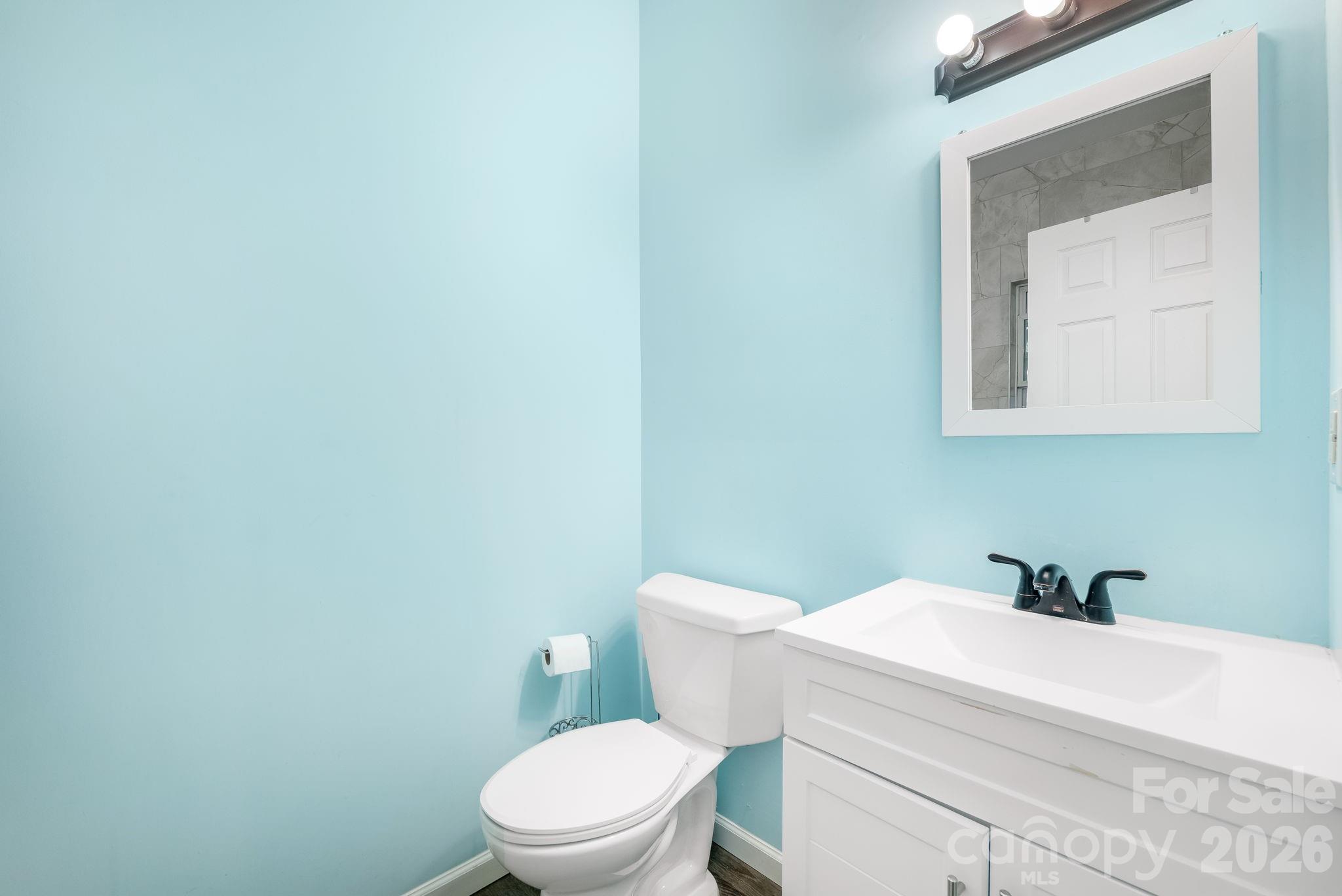 845 Spindale Street Spindale, NC 28160 - Photo 20 of 27 a white toilet sitting next to a bathroom sink