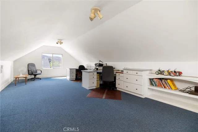 a spacious bedroom with a bed and a couch