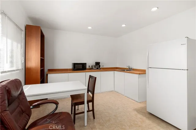 a view of a livingroom with furniture window and a ceiling fan