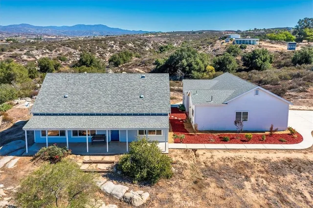 a bathroom with a shower curtain and a window