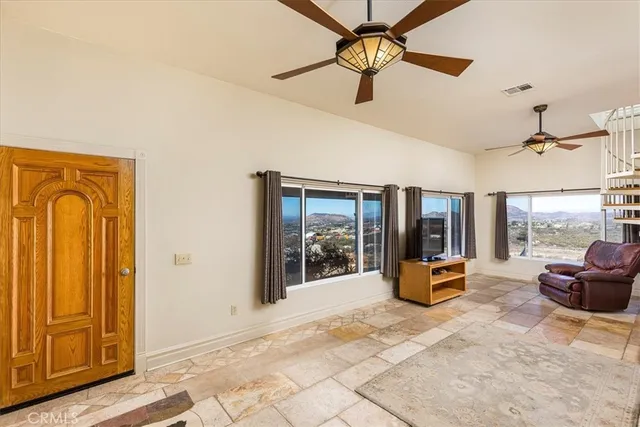 a view of a room with wooden floor and windows