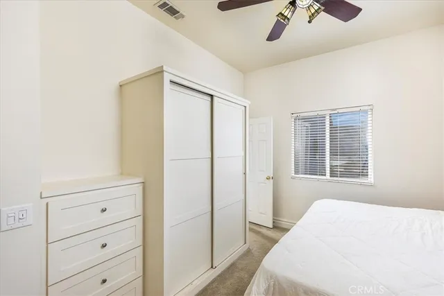 a living room with furniture and a ceiling fan