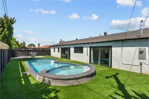 a view of a house with a backyard porch and sitting area