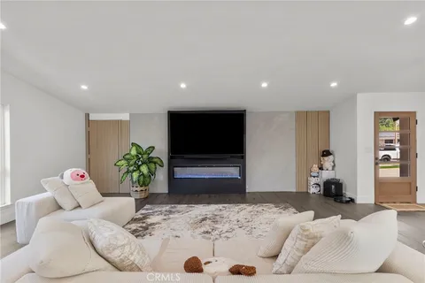 a bedroom with furniture and a flat screen tv