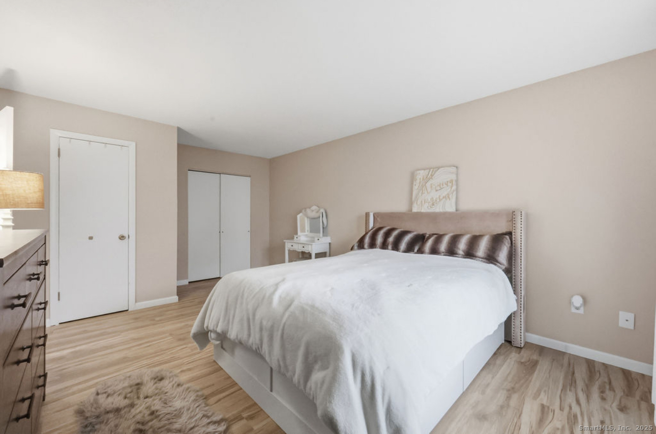 39 Cottonwood Road, Unit 39 Newington, CT 06111 - Photo 11 of 21 a bedroom with a bed and a flat screen tv