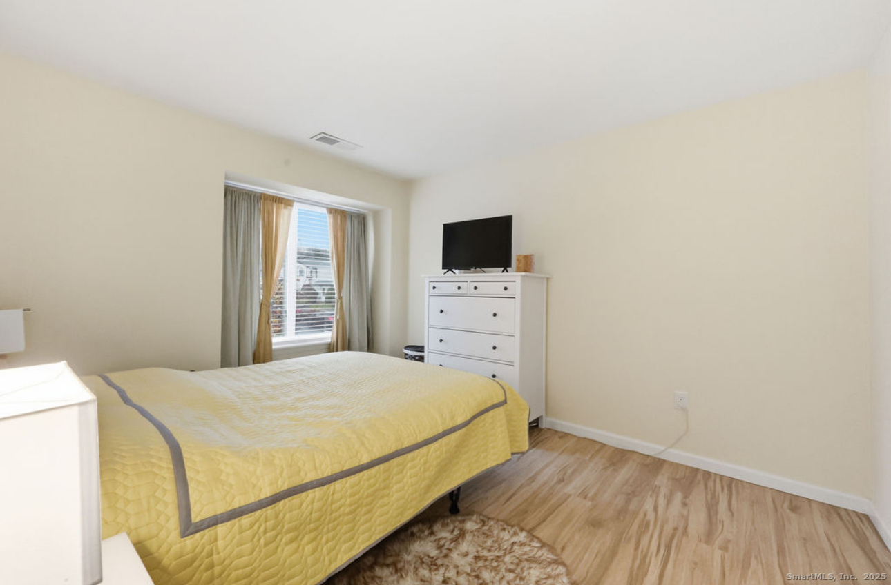 39 Cottonwood Road, Unit 39 Newington, CT 06111 - Photo 14 of 21 a bedroom with a bed and a flat tv screen on dresser