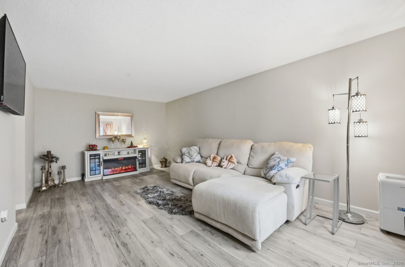 39 Cottonwood Road, Unit 39 Newington, CT 06111 - Photo 2 of 21 a living room with furniture and a wooden floor