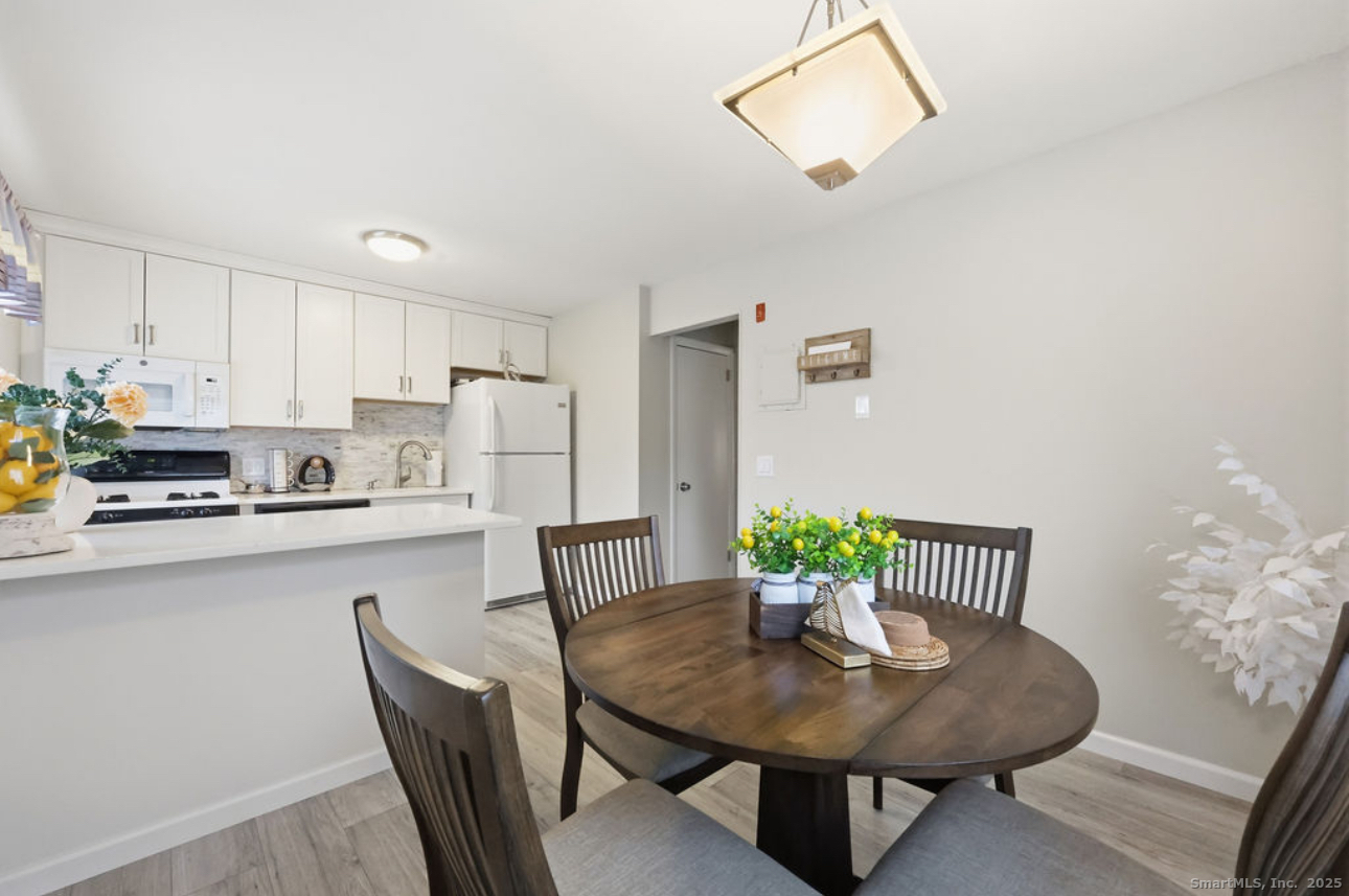 39 Cottonwood Road, Unit 39 Newington, CT 06111 - Photo 5 of 21 a view of a dining room with furniture and wooden floor