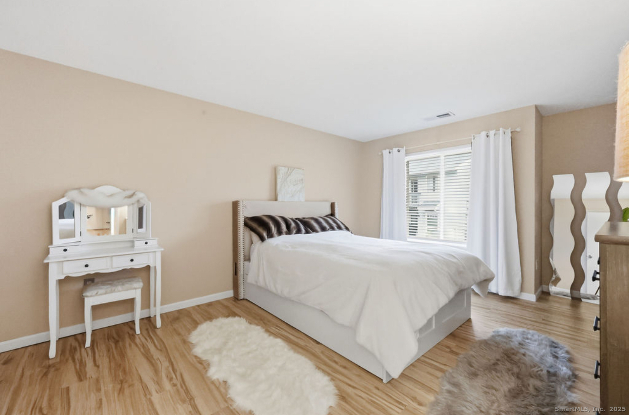 39 Cottonwood Road, Unit 39 Newington, CT 06111 - Photo 10 of 21 a bedroom with a bed and wooden floor