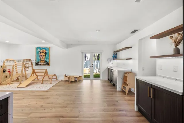 a view of a kitchen with furniture and wooden floor